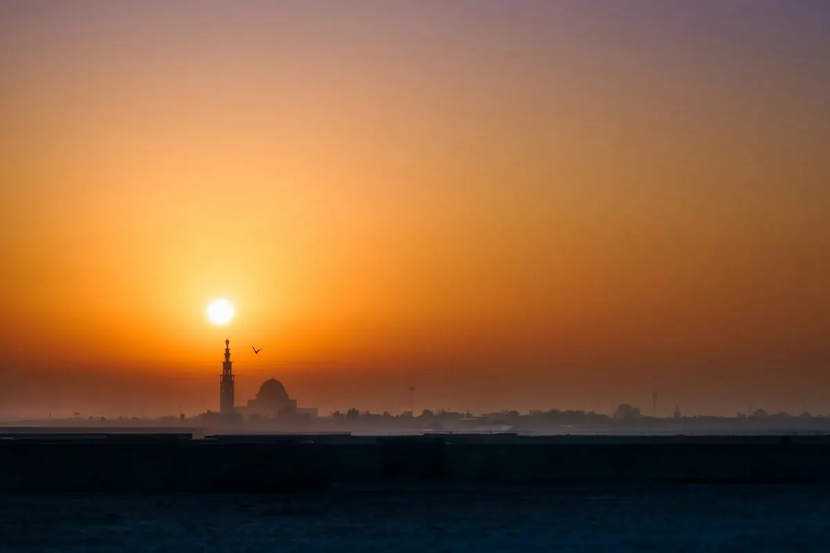 Sofa Cleaning Ajman — sunset skyline Sunset over Ajman with mosque minaret silhouette on the skyline — at-home sofa cleaning service in Ajman by Al Haya Sofa Care
