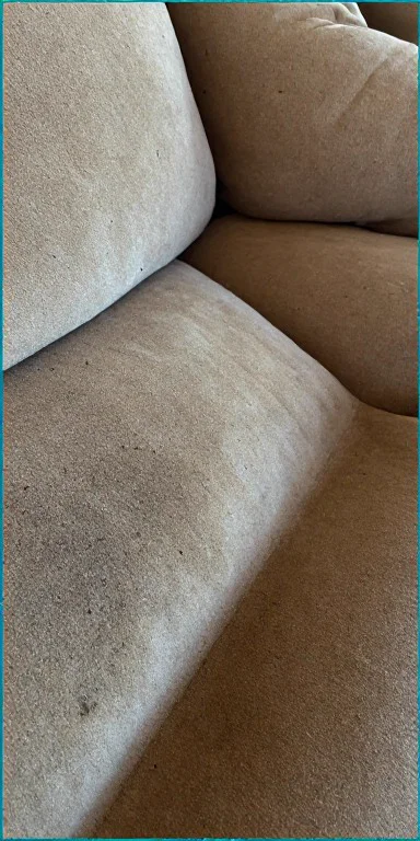 Dirty beige suede fabric sofa with stains and grime before deep shampoo cleaning in Abu Dhabi UAE